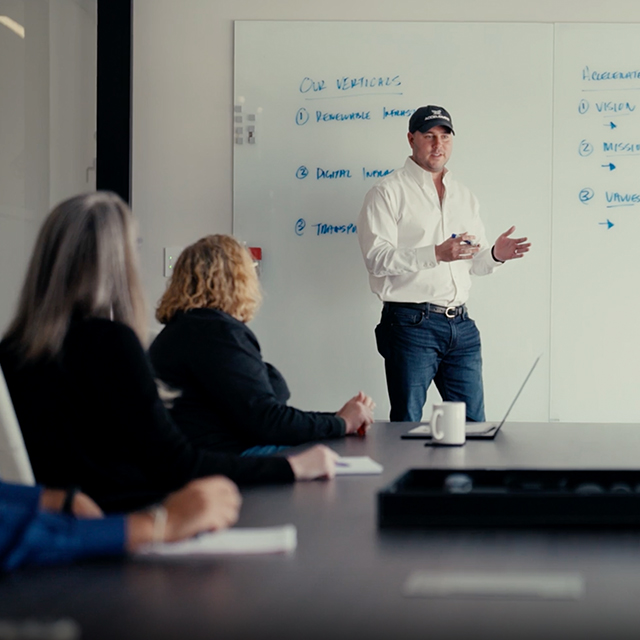 An Accelerate employee presenting at a whiteboard