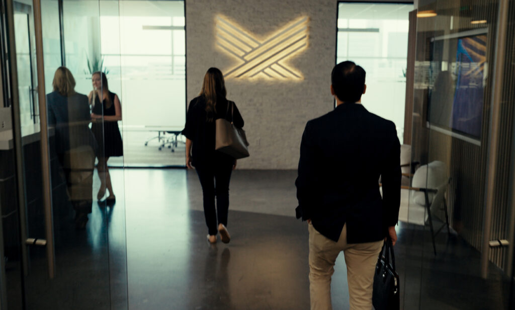 Accelerate employees walking through the main lobby of Accelerate's office